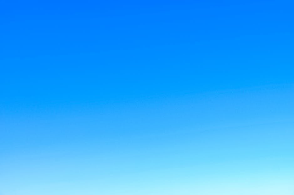 A serene view of a vibrant clear blue sky with a subtle gradient, perfect for backgrounds.